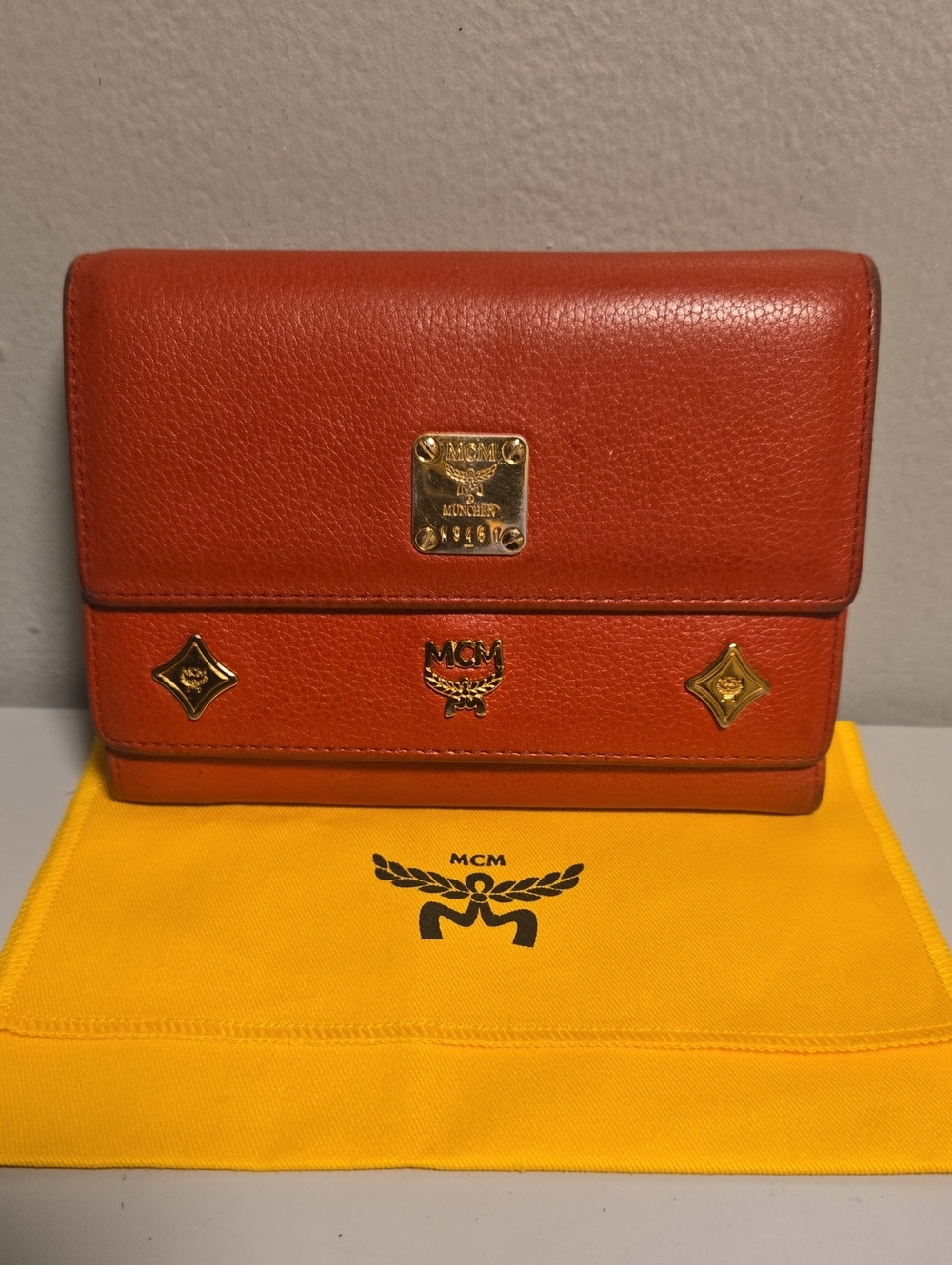 MCM Orange Leather Flap Wallet with Gold Plaques